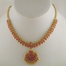 Golden necklace with a ruby