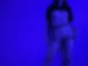 Lauren in strip tries on a harness