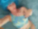Blue wig, bare stomach. I'm lying on the carpet.